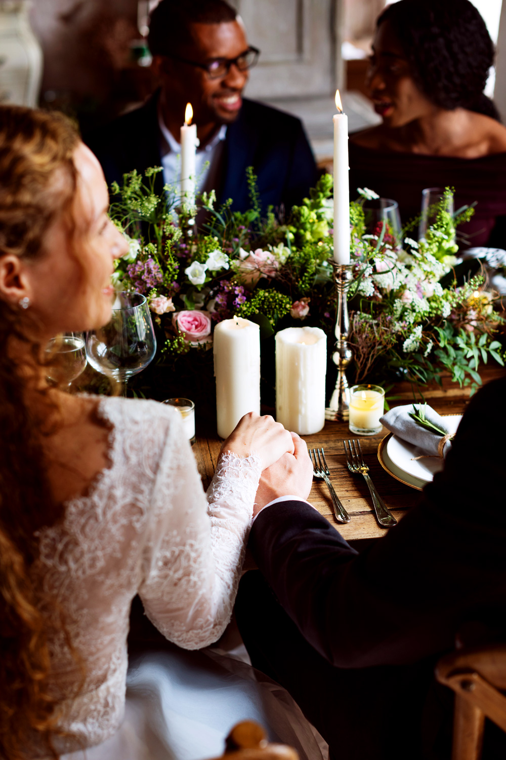 Happy wedding reception holding hands